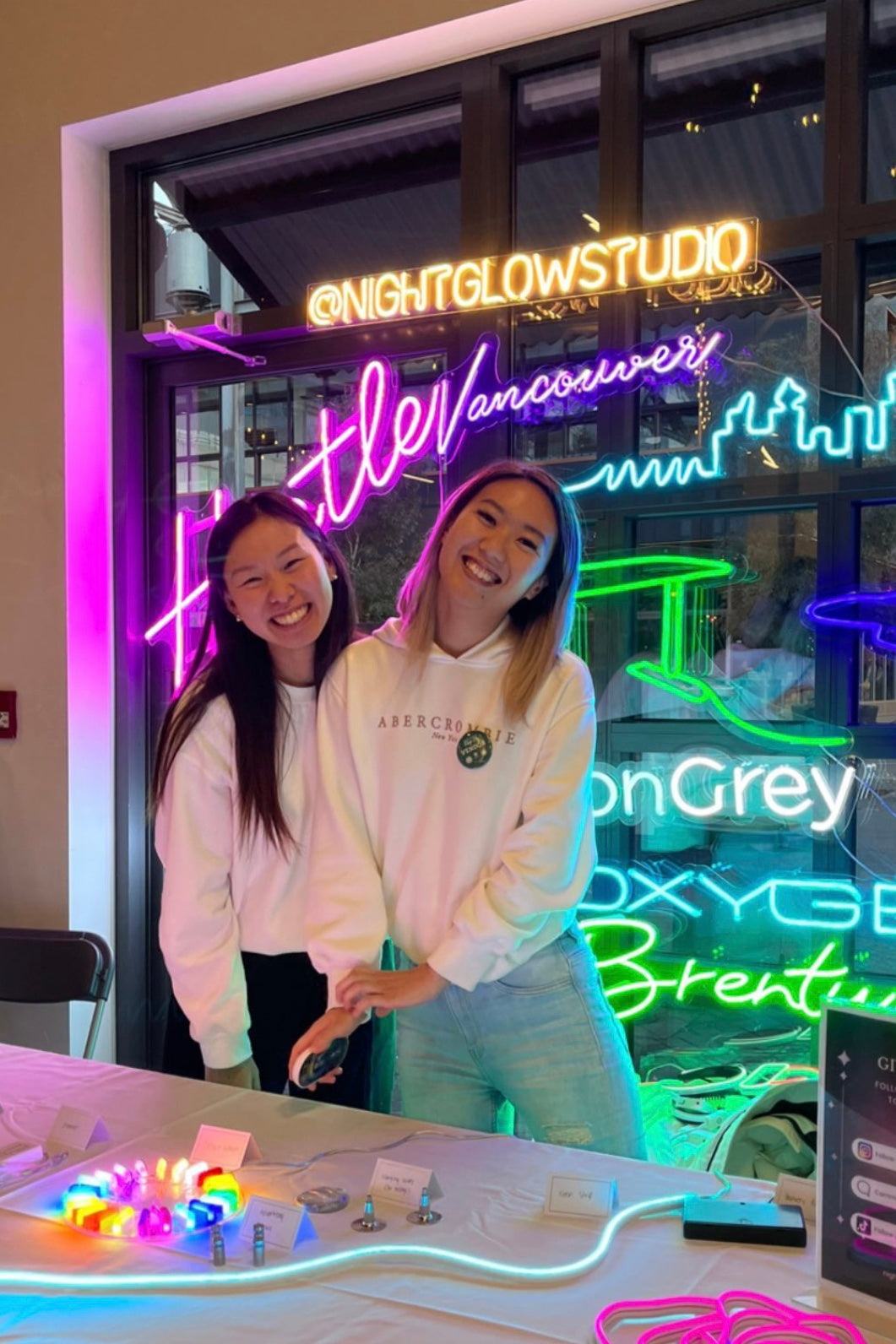 Vancouver Custom Neon Sign at the Etsy Pop in North Vancouver. Selena and Melissa in from of nightglow studio pop booth