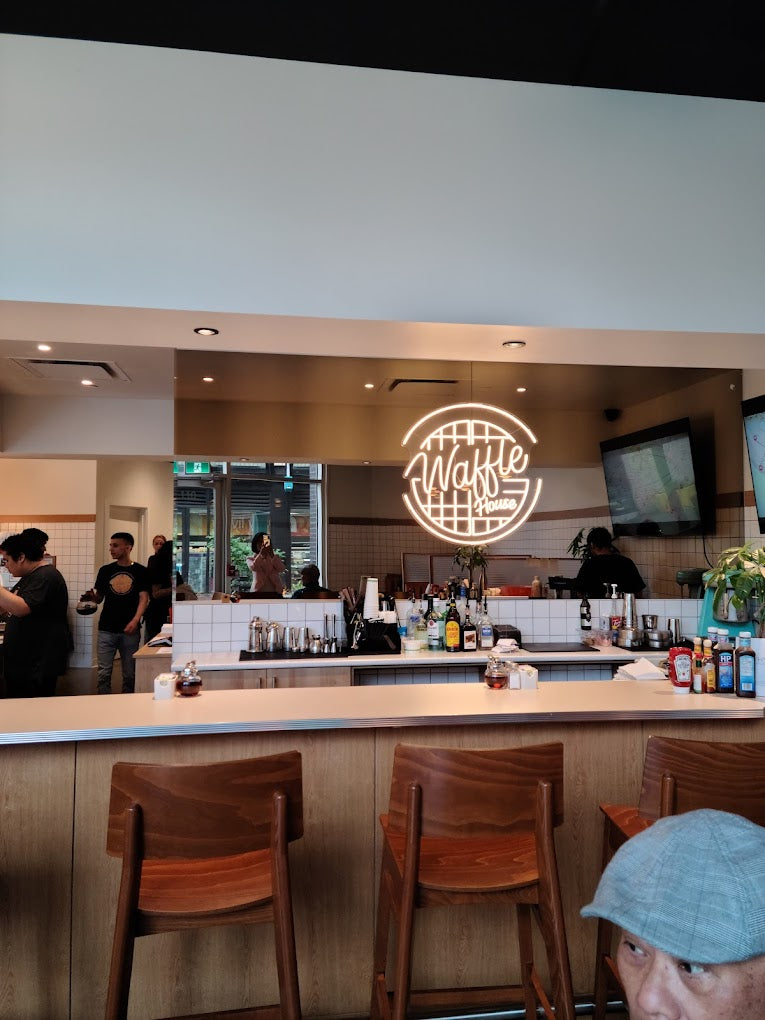 neon sign behind a bar