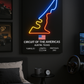 Neon sign of Circuit of the Americas in a bedroom setting with gaming equipment.