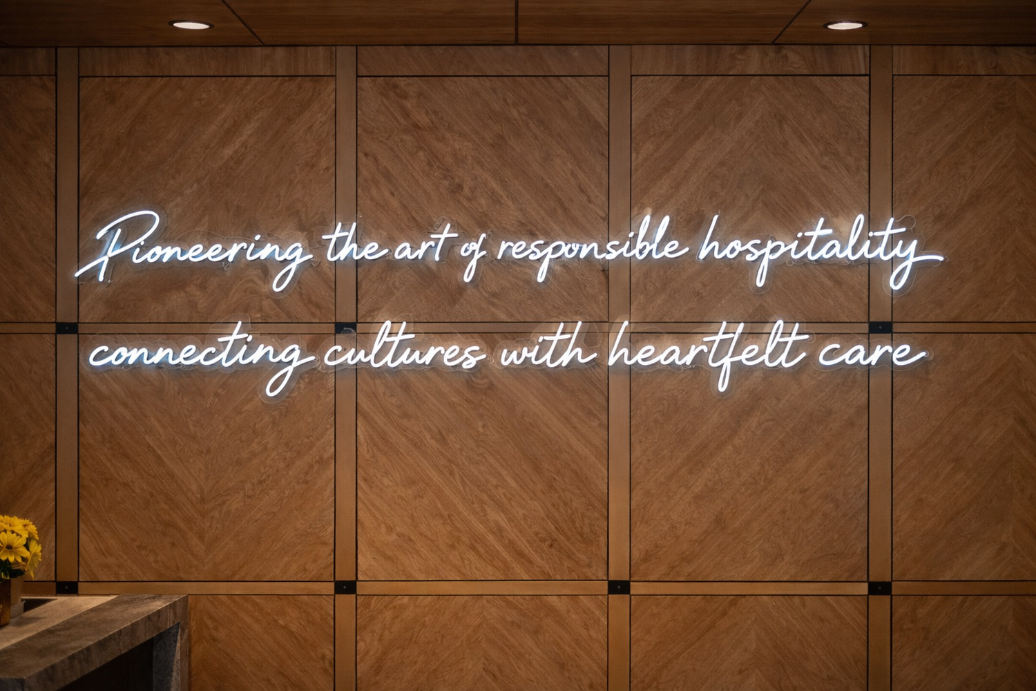 Cool White custom neon sign on wooden wall with text about responsible hospitality and cultural connection.