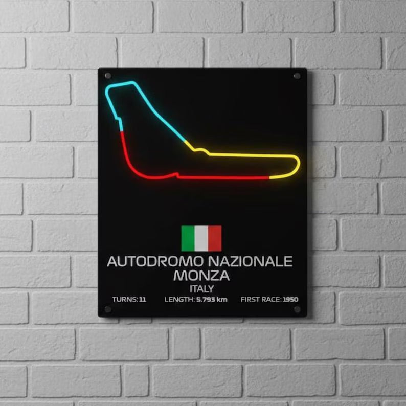 F1 Neon sign of a race track on a black background with text about Autodromo Nazionale Monza Italy, mounted on a brick wall.