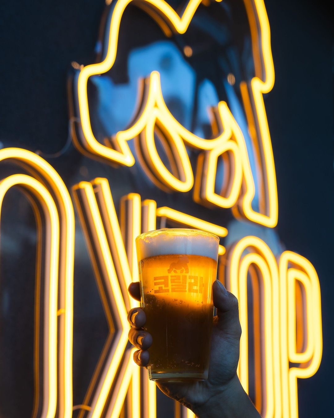 golden yellow neon sign in korean at a bar and restaurant