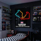 Neon sign of a race track layout on a wall in a bedroom with racing-themed decor.