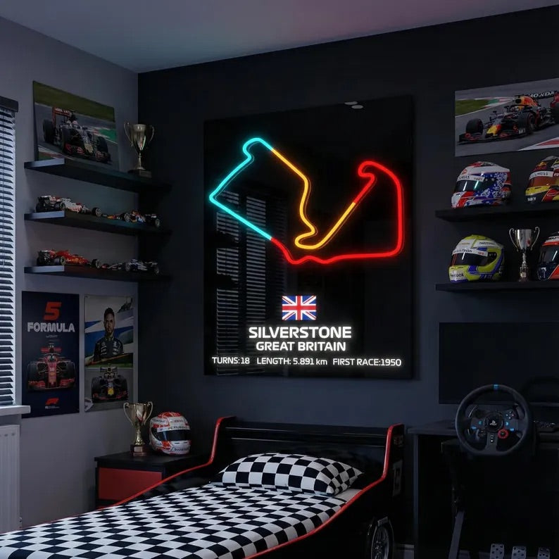 Neon sign of a race track layout on a wall in a bedroom with racing-themed decor.