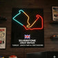 Neon sign of Silverstone circuit layout on a wooden wall with racing memorabilia.