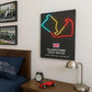 Neon-style poster of Silverstone circuit on a wall above a bed with racing-themed decor.