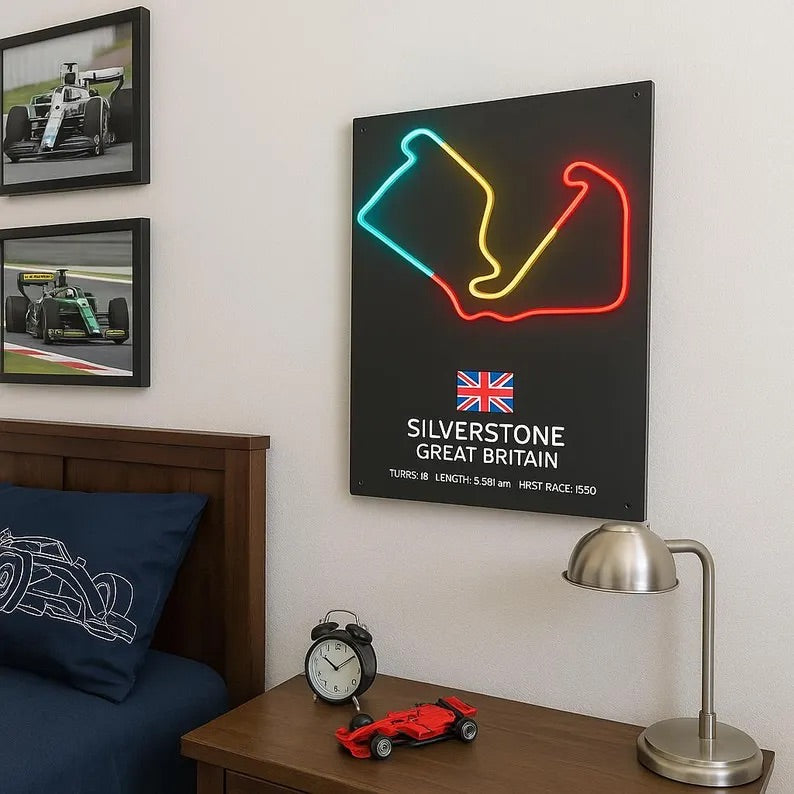 Neon-style poster of Silverstone circuit on a wall above a bed with racing-themed decor.