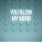 Neon sign with 'YOU BLOW MY MIND' text on a wall with hair dryers.