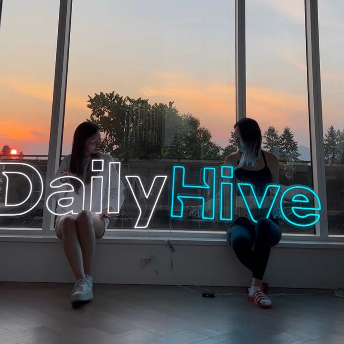 neon sign for dailyhive corporate office