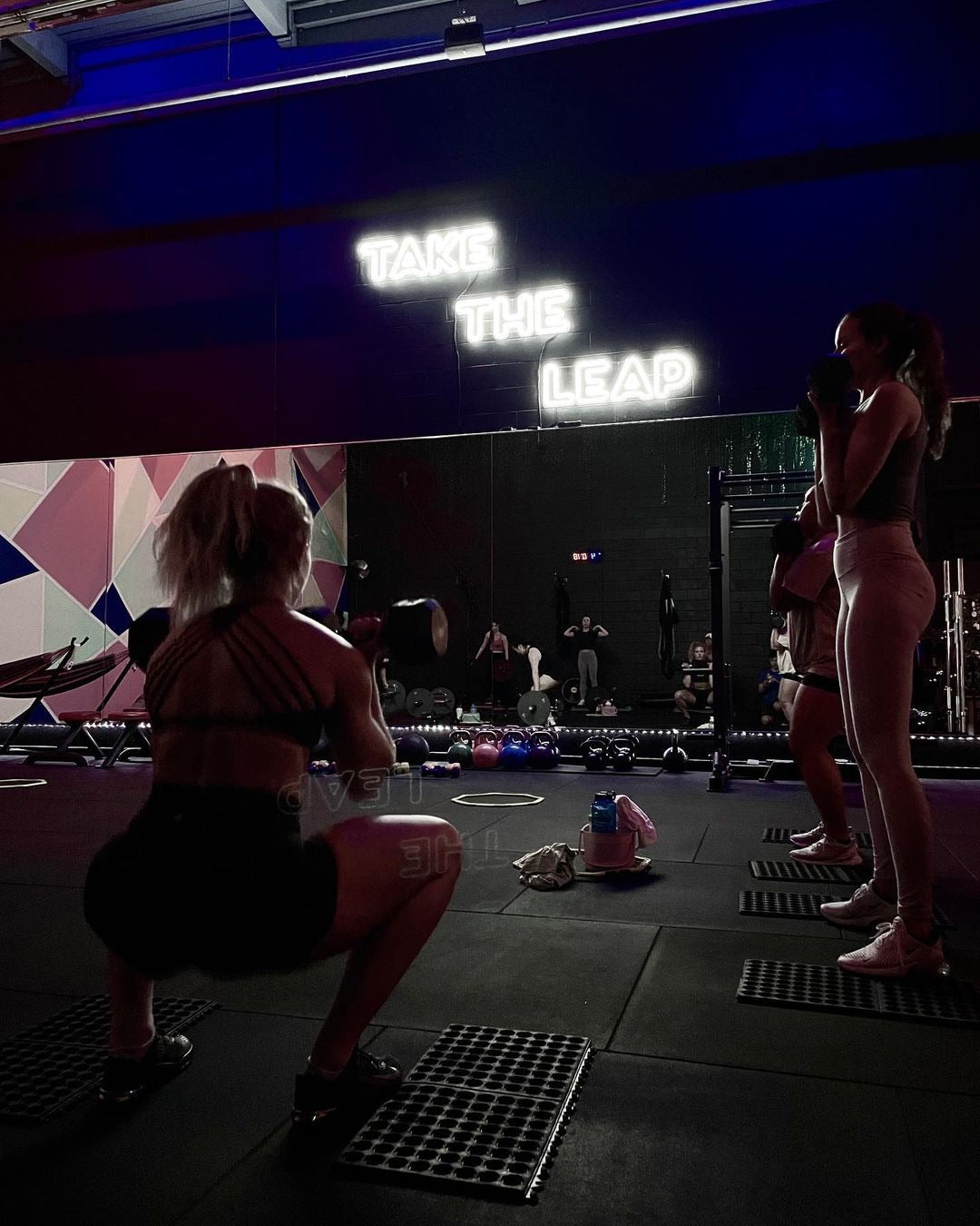 gym with neon sign says take the leap for motivation and branding