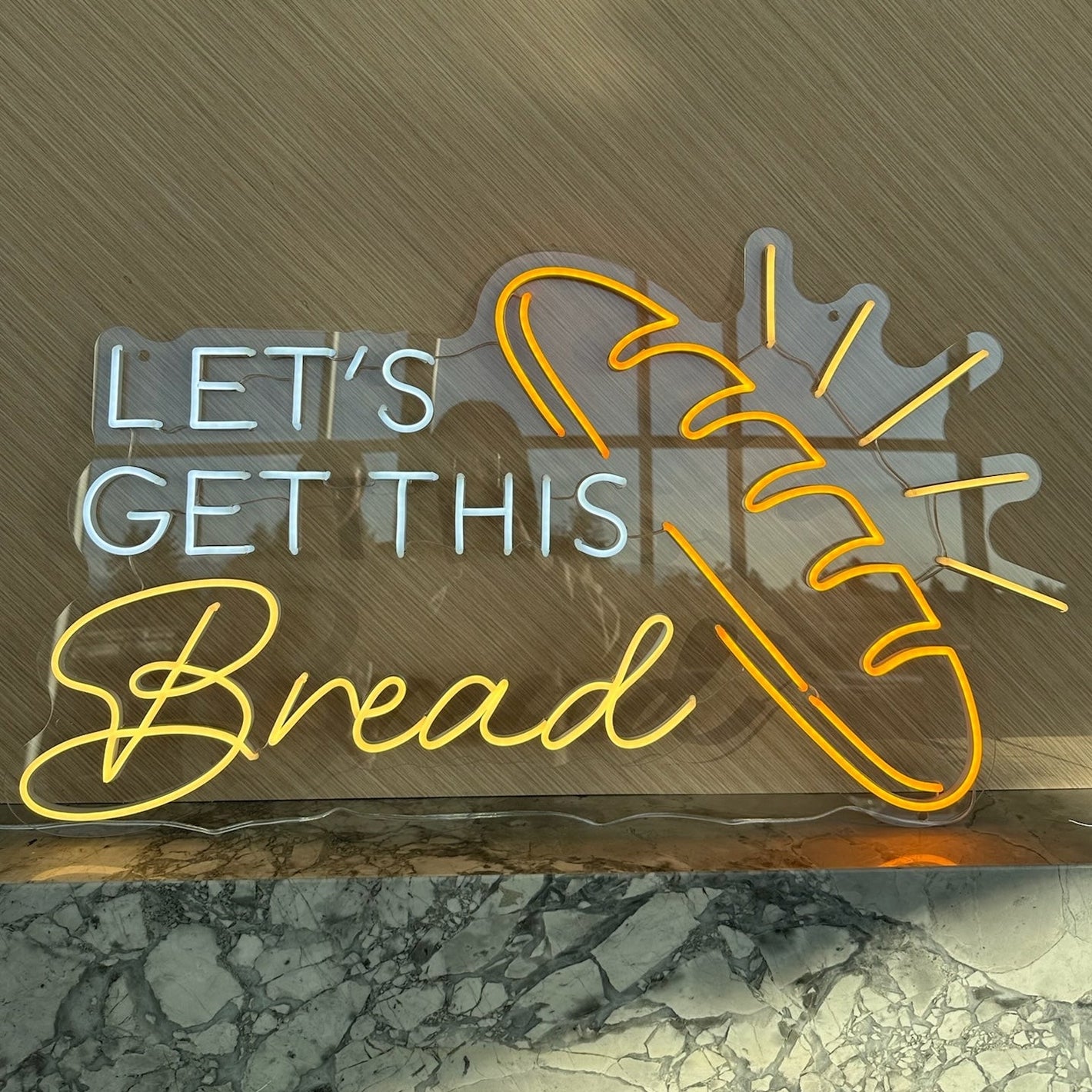 neon sign says let's get this bread