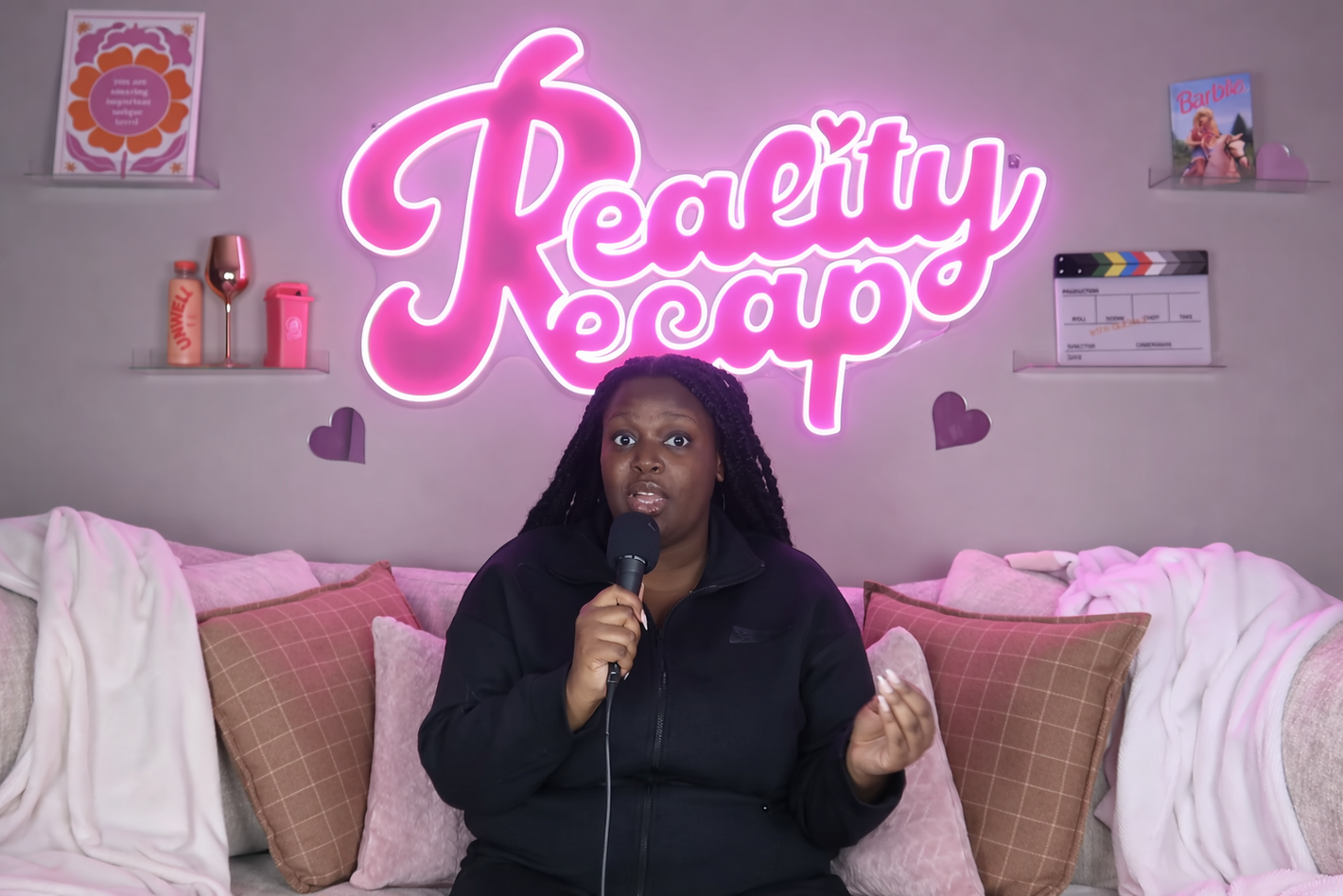 neon sign for podcast studio reality recap in pink letters