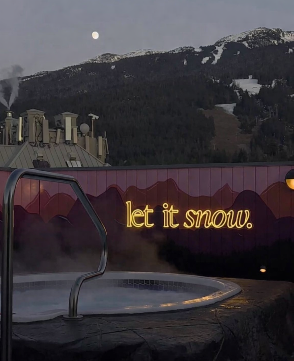 let it snow warm white neon sign by rooftop hot tub in whistler