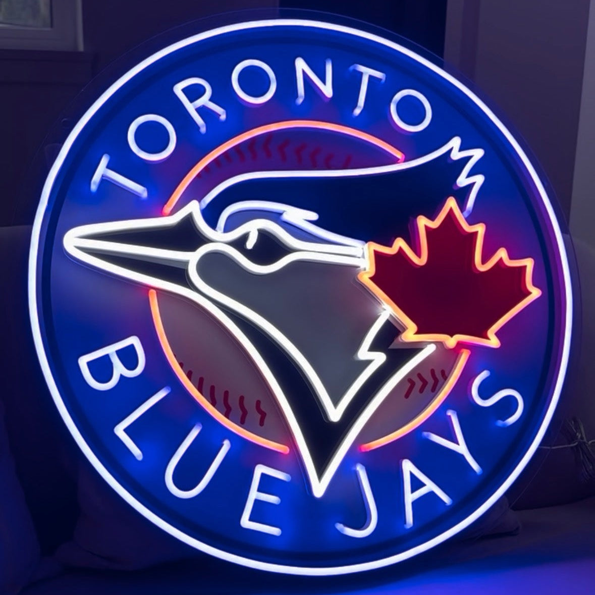 Neon sign of the Toronto Blue Jays logo on a dark background