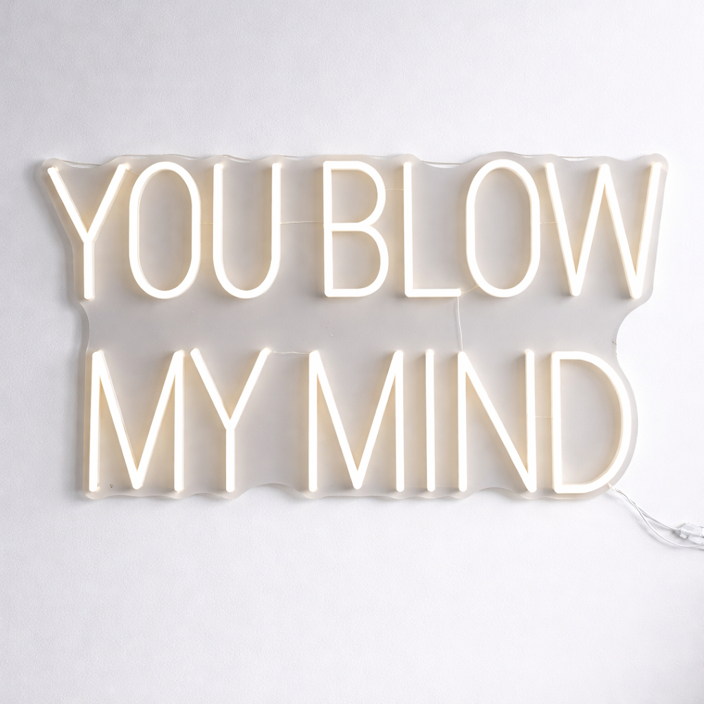 Neon sign with the text 'YOU BLOW MY MIND' for hair salon