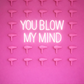 Pink wall with multiple hair dryers and a neon sign saying 'You Blow My Mind'.
