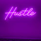 Hustle neon sign in bedroom above bed
